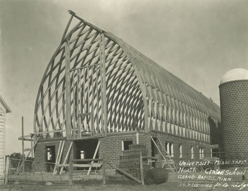 historic photo of a barn getting built